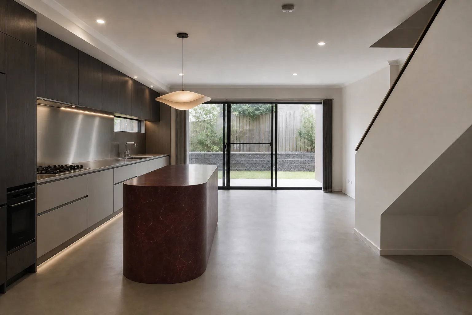 Representative contemporary townhouse kitchen concept after renovation with charcoal cabinetry and burgundy stone
